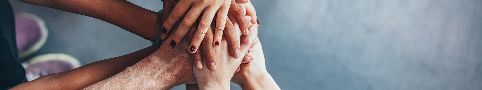 Image of women's hands in a stacked in unity