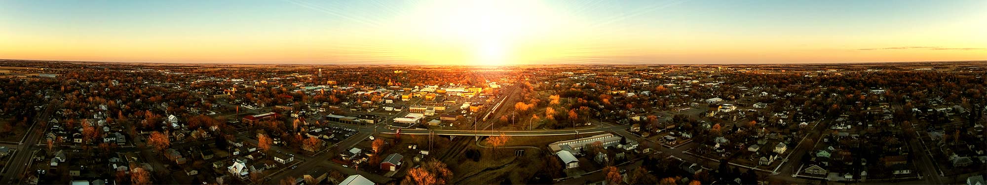 Image of a small city at sunset with roadways crisscrossing the landscape