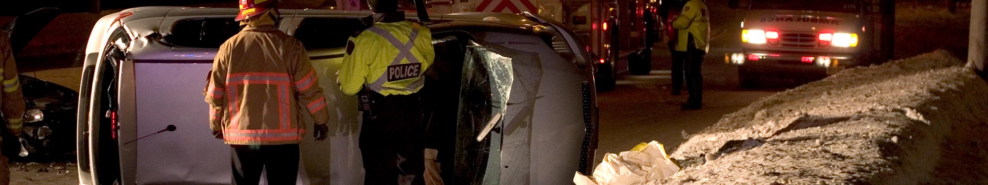 Image of first responders on scene of vehicle roll-over crash