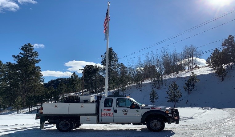 image-of Engine 642 in front of flagpole in the snow at Lead District Office