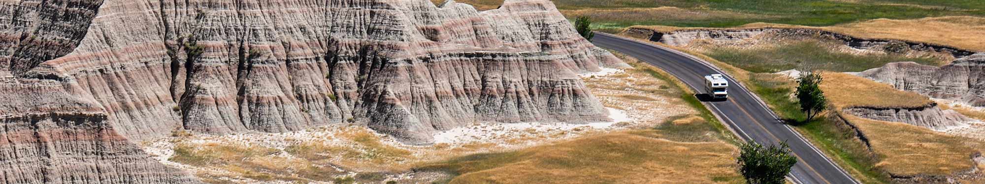 Image of Class B motorhome driving on roadway through Badlands National Park in South Dakota