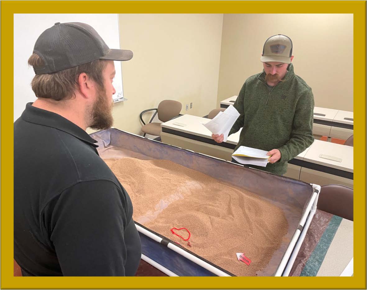Image of trainer and student at sand table exercise