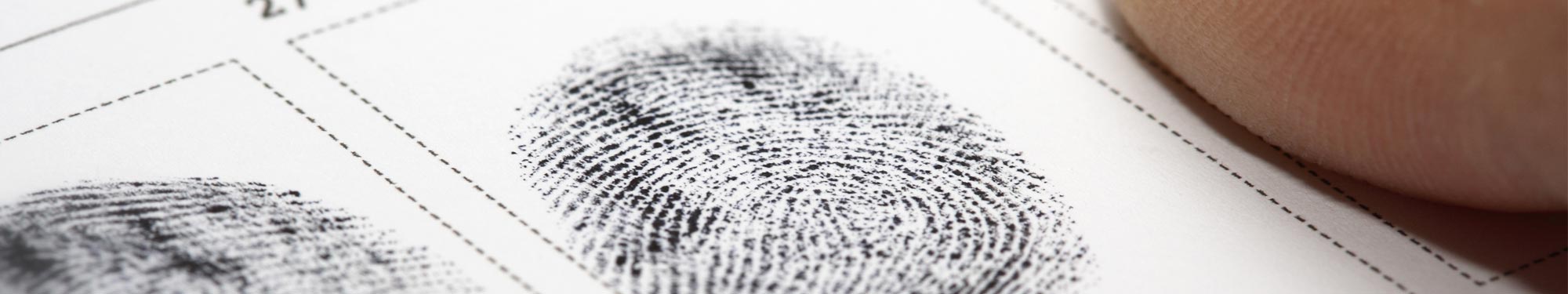 Image of fingerprinting card with black fingerprints on it