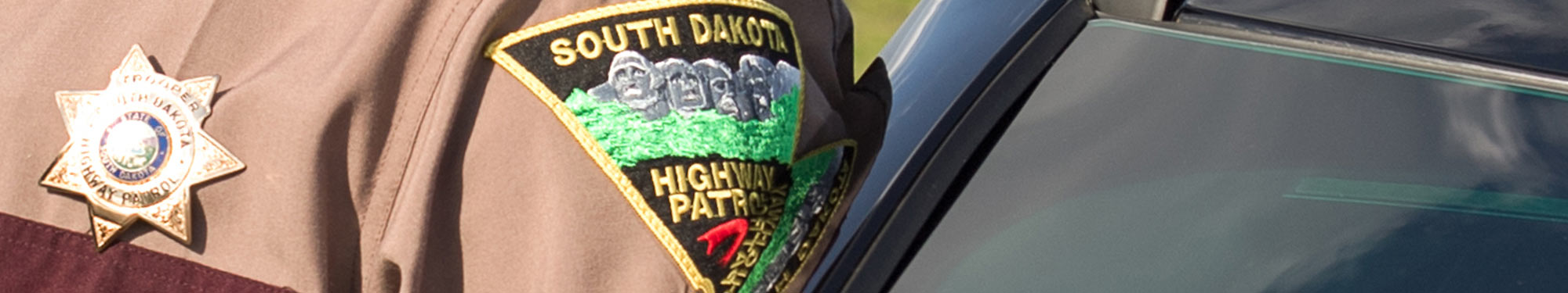 Image of South Dakota Highway Patrol Trooper with badge on uniform