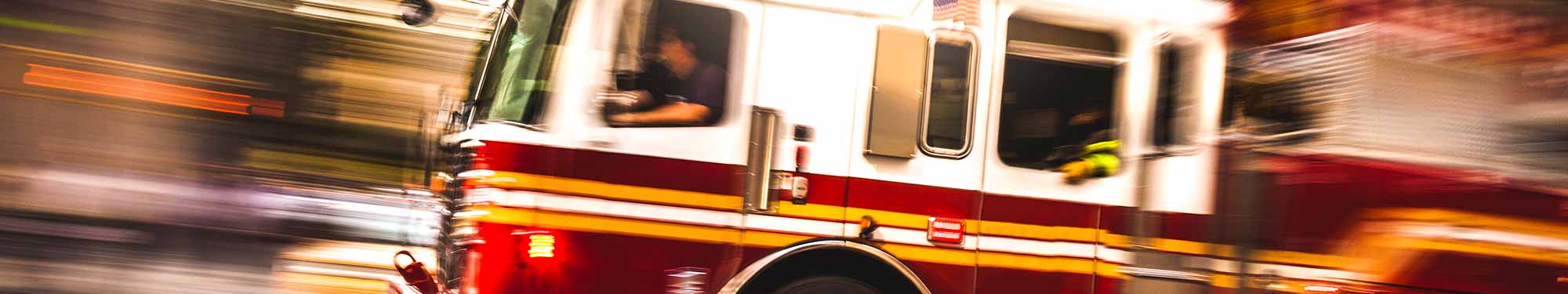 Image of blurred fire truck responding to a call