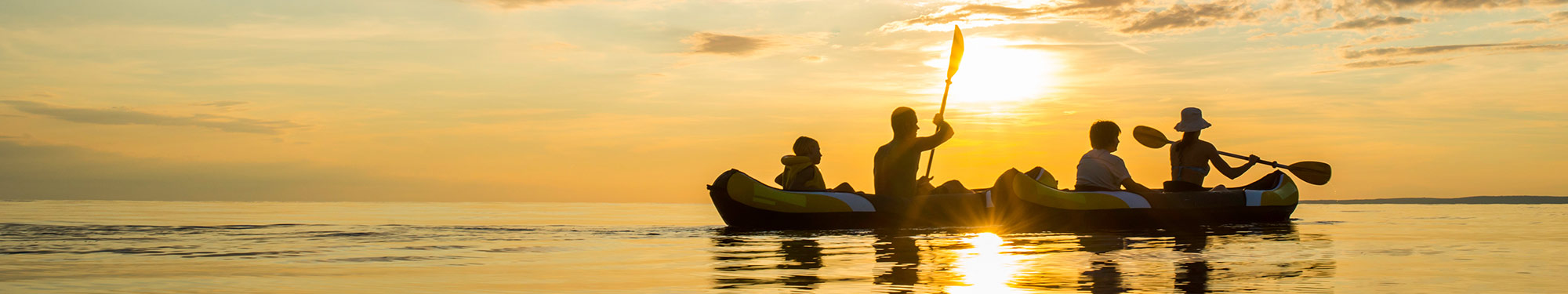 Image of two two-person kayaks on the water at sunset