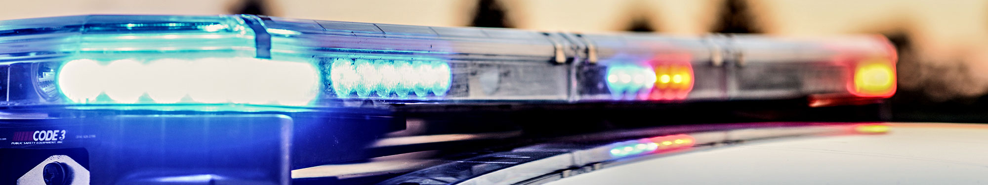 Image of activated light bar on top of law enforcement vehicle