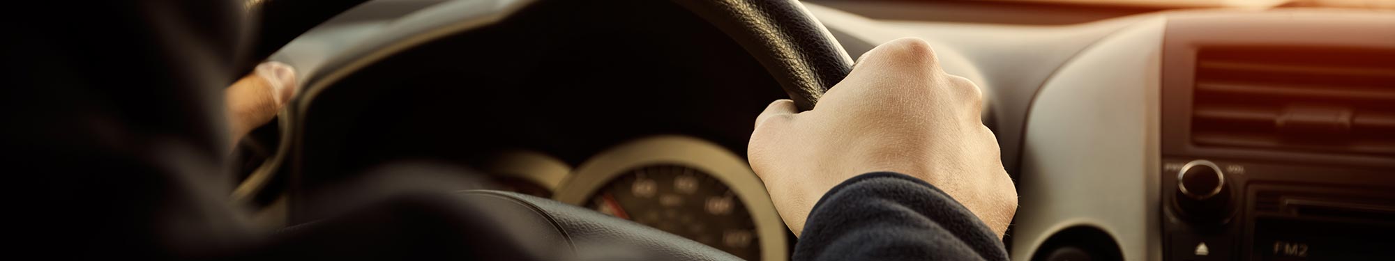 Image of hands on a steering wheel