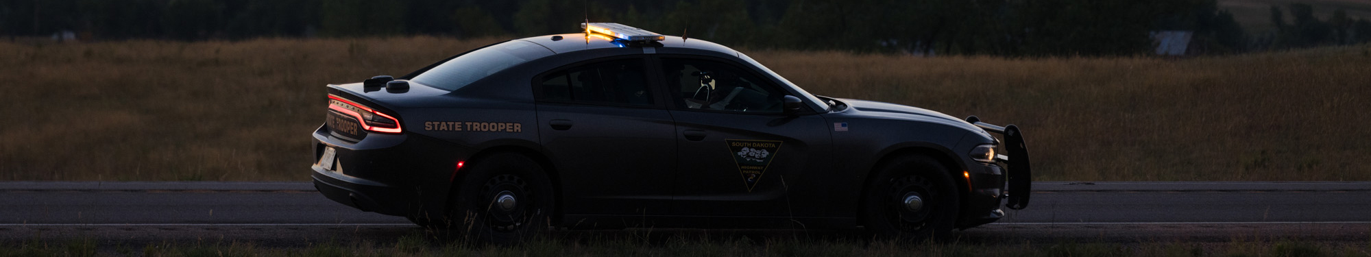 Image of black Highway Patrol vehicle on the roadway
