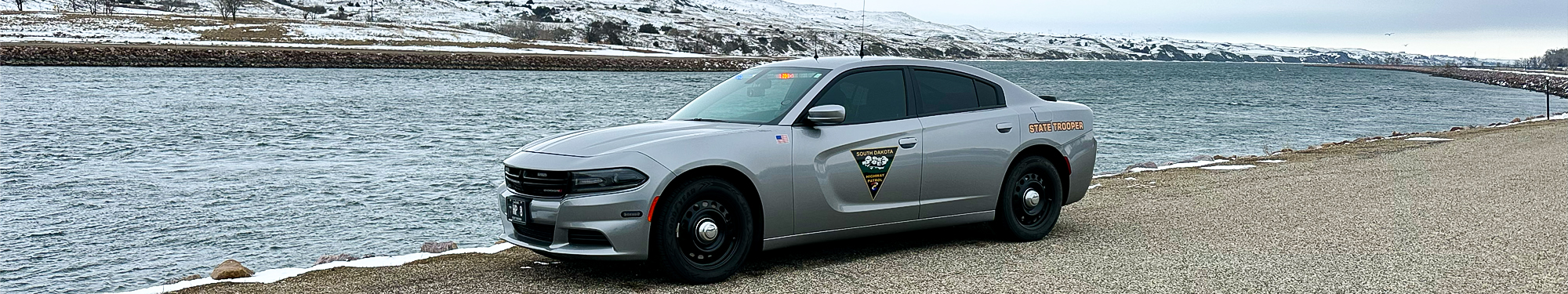 Image of South Dakota Highway Patrol trooper vehicle parked next to a lake